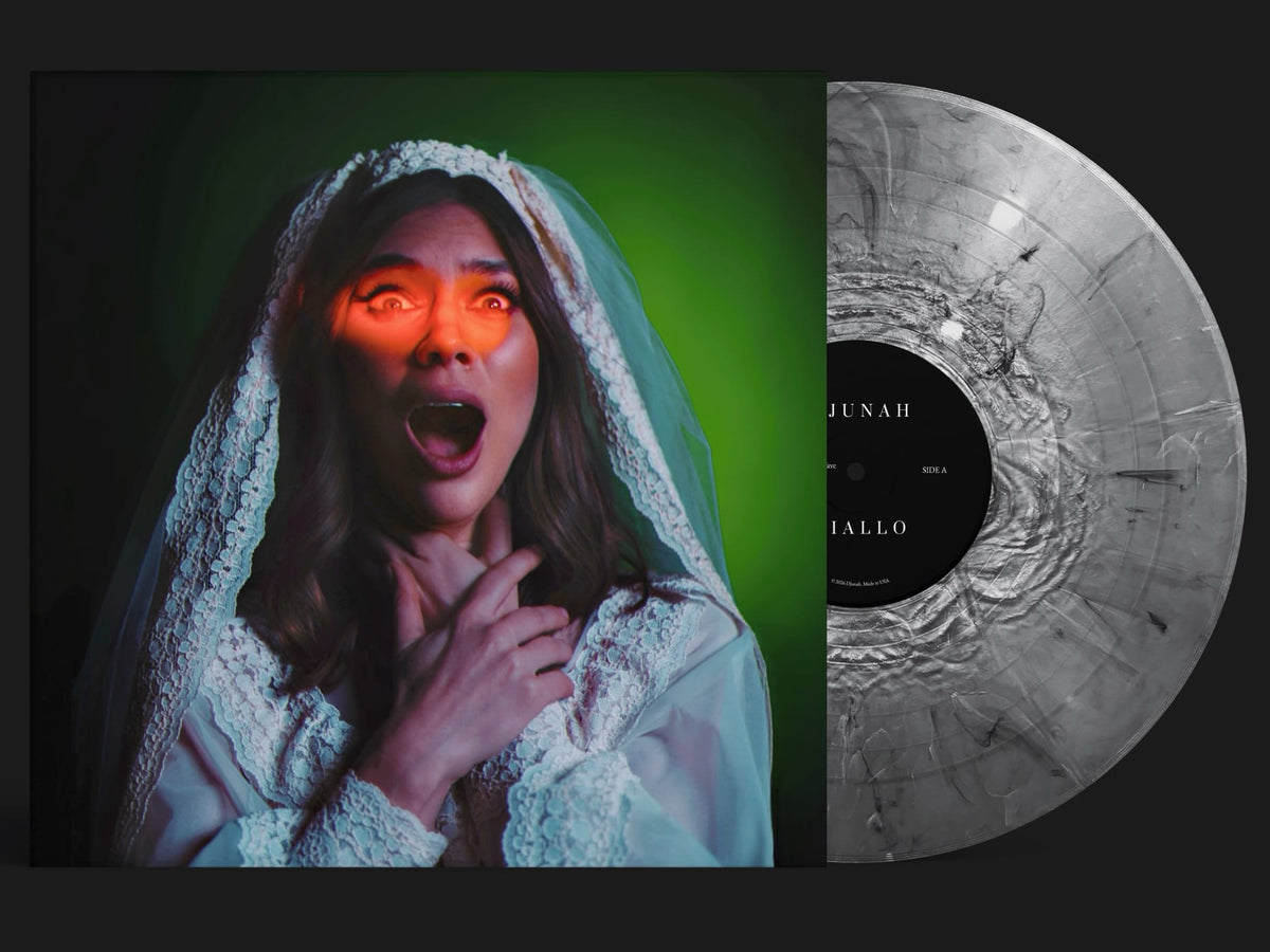 Vinyl record album cover and partial record sleeve shown side by side. The left half features a woman in a white lace bridal veil with dramatic green and orange lighting.
